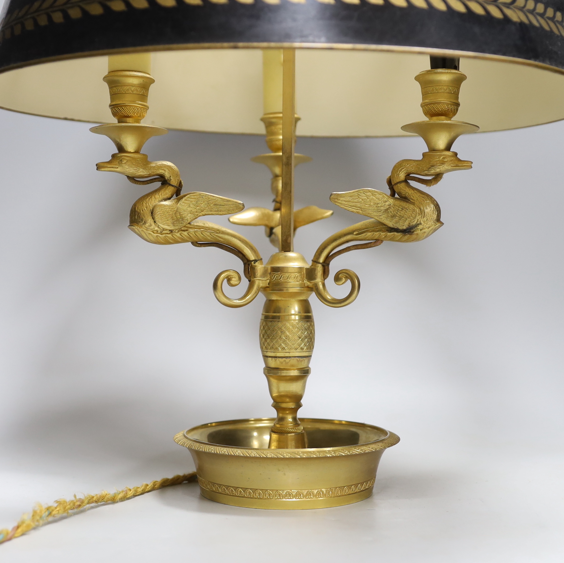 A Regency style gilt three light swan branch and toleware shaded table lamp, 65cm high